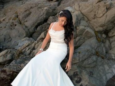 bride sitting on rocks