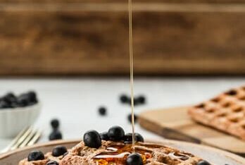 drizzle of syrup over waffle with blueberries
